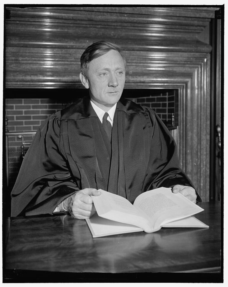 Douglas dons robes of Supreme Court Justice.